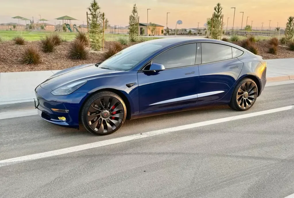 A dark blue Tesla Model 3